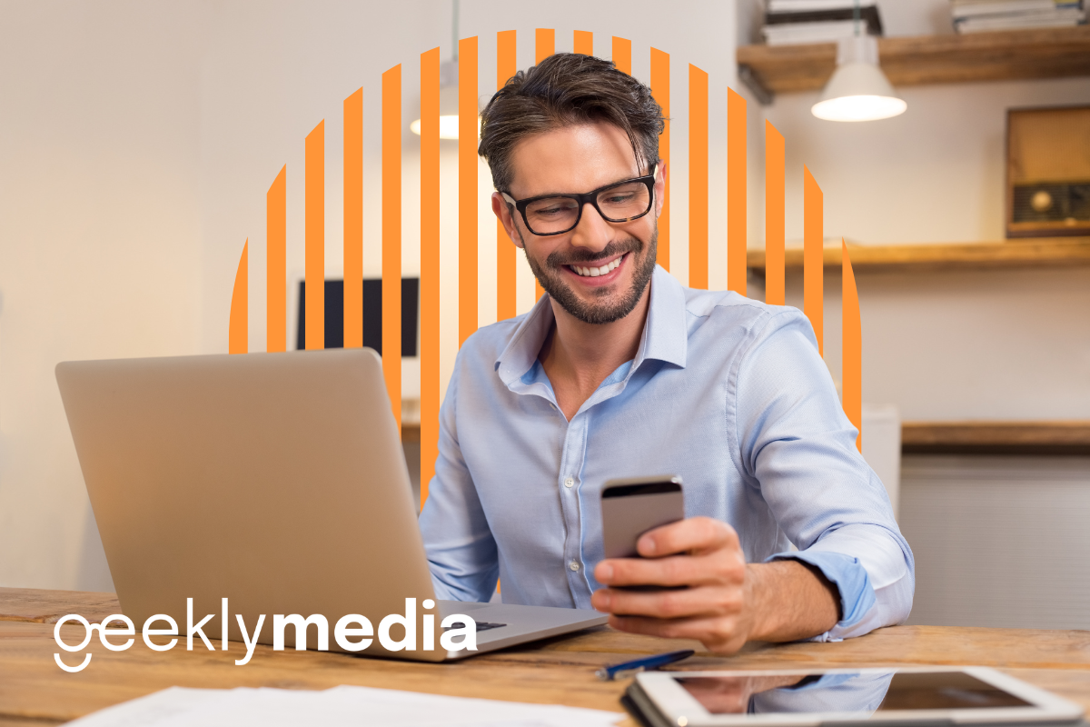 A man smiling looking at his phone