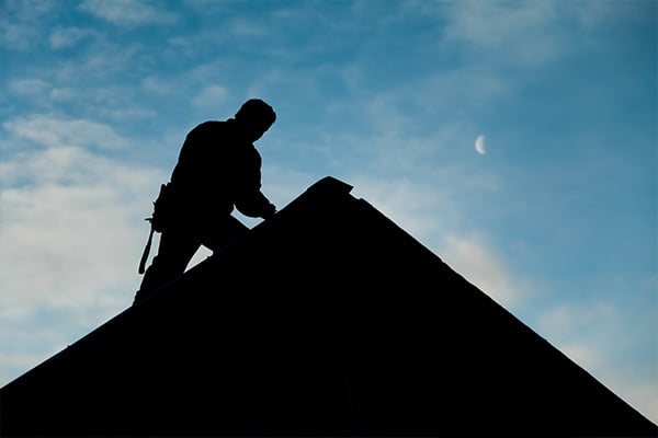 Roofer-working-on-roof-silhouette
