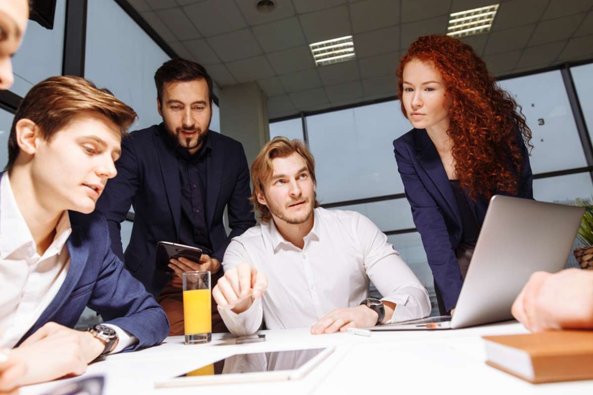 Business executive delivering presentation to his colleagues during meeting or in-house business training