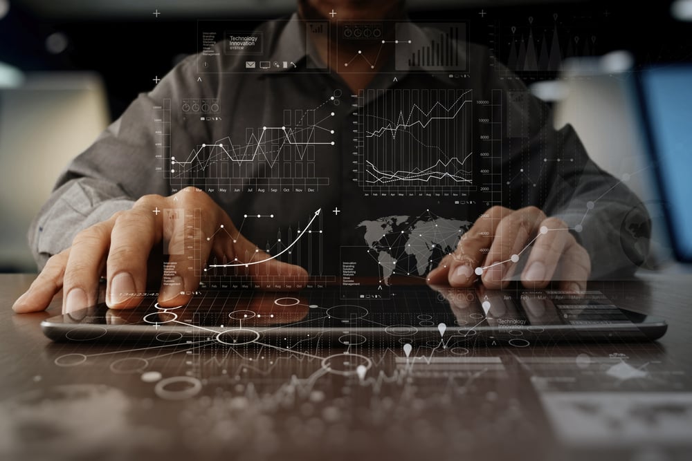 Businessman hands working on a tablet, property management marketing automation concept.